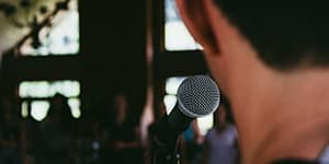 Photo of a man behind a microphone