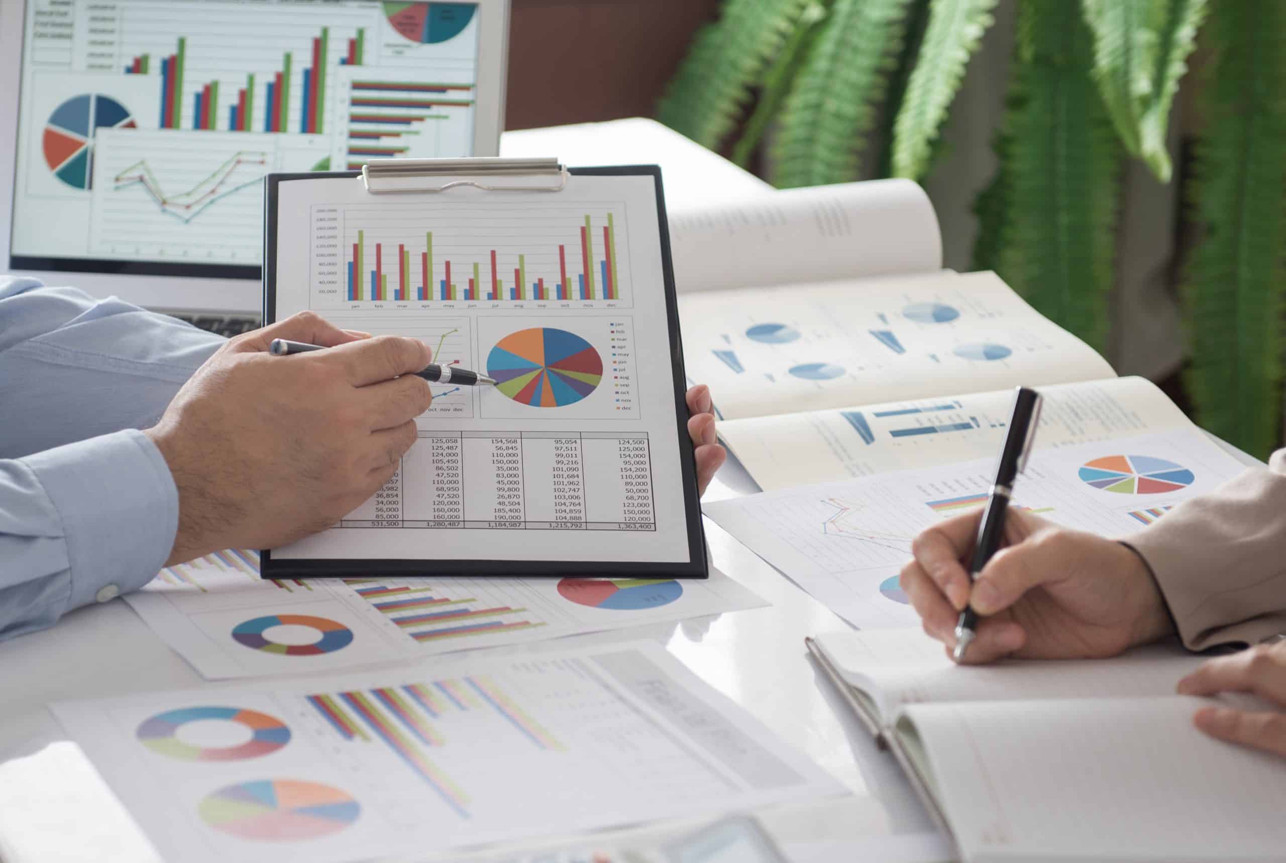business people presentation data of financial or marketing figures, graphs and charts for reviewing market data and business strategy plan.